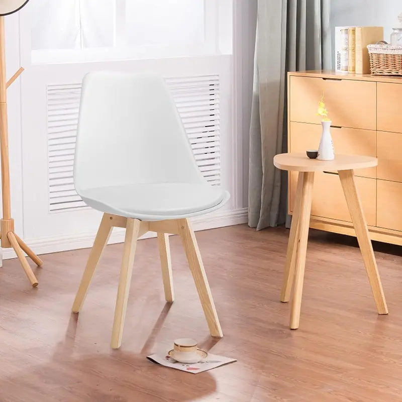 Set of Four Mid-Century Modern Armless Dining Chairs: Padded Seats, Wood Legs, and Clean White Finish for Kitchens and Waiting Areas